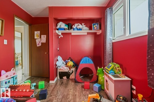 Playroom featuring a textured ceiling and dark wood-type flooring - 11516 152A Avenue, Edmonton, AB - Indoor
