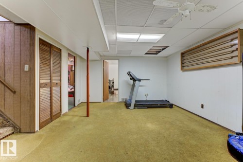 Workout area featuring carpet flooring, a drop ceiling, and ceiling fan - 11516 152A Avenue, Edmonton, AB - Indoor