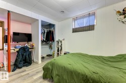 Bedroom featuring a closet and wood finished floors - 