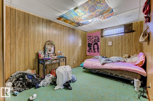 Carpeted bedroom with wood walls - 11516 152A Avenue, Edmonton, AB - Indoor Photo Showing Other Room