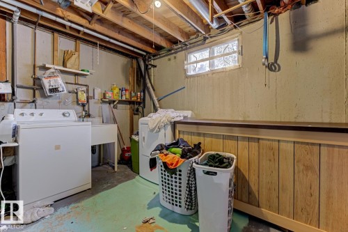 Below grade area with washing machine and clothes dryer - 11516 152A Avenue, Edmonton, AB - Indoor