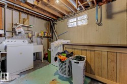 Below grade area with washing machine and clothes dryer - 