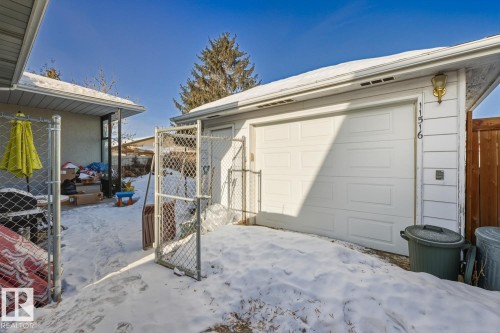 Snow covered garage featuring a gate - 11516 152A Avenue, Edmonton, AB - Outdoor With Exterior