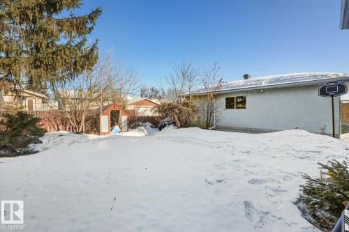 Yard covered in snow with a storage shed - 11516 152A Avenue, Edmonton, AB - Outdoor