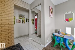 Dining room featuring brick wall and tile patterned flooring - 