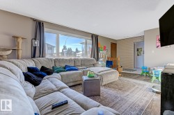 Living area featuring wood finished floors and brick wall - 