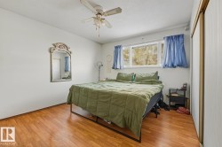 Bedroom with light wood finished floors, a ceiling fan, a closet, and a textured ceiling - 
