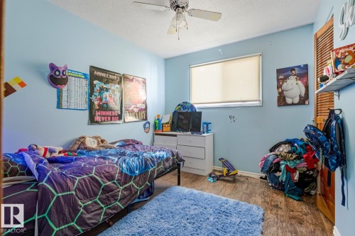 Bedroom featuring a textured ceiling, wood finished floors, and a ceiling fan - 11516 152A Avenue, Edmonton, AB - Indoor Photo Showing Bedroom
