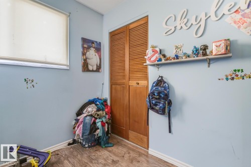 Recreation room featuring wood finished floors and baseboards - 11516 152A Avenue, Edmonton, AB - Indoor