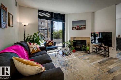 205 11933 Jasper Avenue, Edmonton, AB - Indoor Photo Showing Living Room With Fireplace