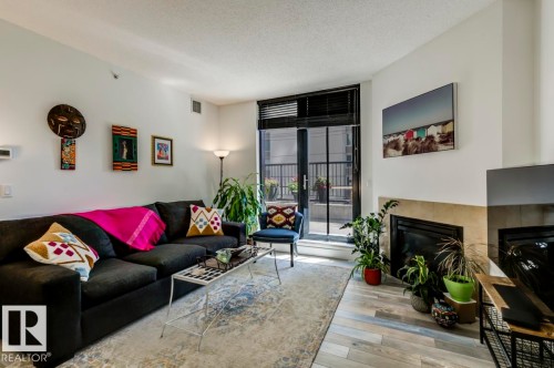 205 11933 Jasper Avenue, Edmonton, AB - Indoor Photo Showing Living Room With Fireplace