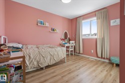 Bedroom with light wood-type flooring and a textured ceiling - 