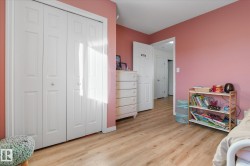 Bedroom with a closet and light wood finished floors - 