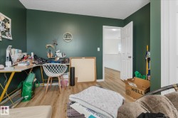 Bedroom featuring wood finished floors and a textured ceiling - 