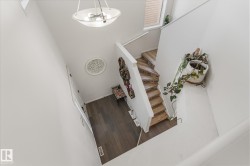 Stairway with wood finished floors and a towering ceiling - 