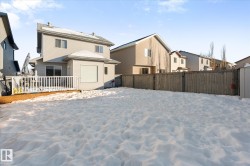 Back of property with a residential view, a wooden deck, and a fenced backyard - 