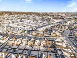 Aerial view of property and surrounding area featuring nearby suburban area - 