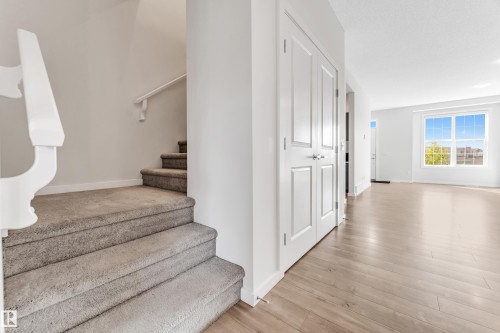 Stairs featuring wood finished floors and baseboards - 2095 Maple Road, Edmonton, AB - Indoor Photo Showing Other Room