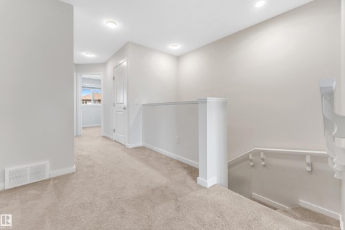 Hall featuring an upstairs landing and light carpet - 2095 Maple Road, Edmonton, AB - Indoor Photo Showing Other Room