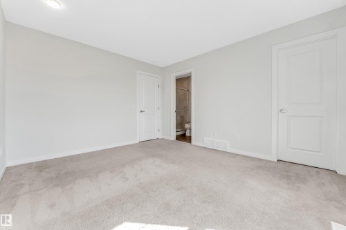 Unfurnished bedroom featuring carpet floors and ensuite bath - 2095 Maple Road, Edmonton, AB - Indoor Photo Showing Other Room