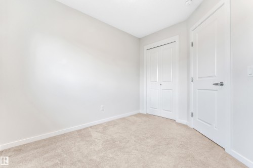 Unfurnished bedroom featuring light colored carpet and a closet - 2095 Maple Road, Edmonton, AB - Indoor Photo Showing Other Room
