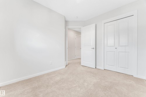 Unfurnished bedroom with light colored carpet and a closet - 2095 Maple Road, Edmonton, AB - Indoor Photo Showing Other Room