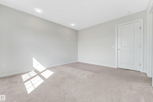 Spare room with light carpet and baseboards - 2095 Maple Road, Edmonton, AB - Indoor Photo Showing Other Room