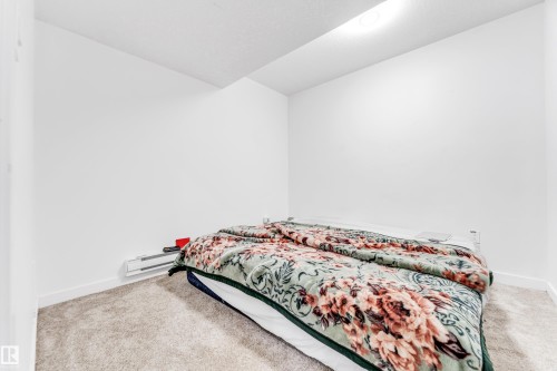 Bedroom with carpet and a baseboard radiator - 2095 Maple Road, Edmonton, AB - Indoor Photo Showing Bedroom