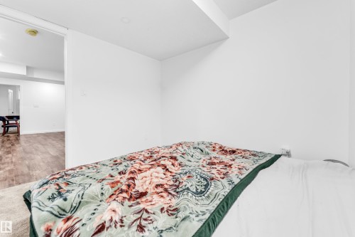 Bedroom featuring wood finished floors - 2095 Maple Road, Edmonton, AB - Indoor Photo Showing Bedroom