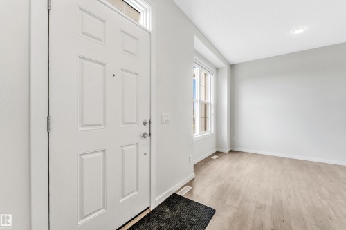 Entryway with light wood-style flooring and baseboards - 2095 Maple Road, Edmonton, AB - Indoor Photo Showing Other Room