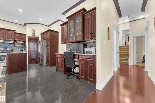 Home office with built in study area, recessed lighting, ornamental molding, and granite floors - 2012 69 Street, Edmonton, AB - Indoor Photo Showing Kitchen