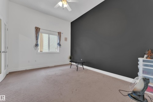 Unfurnished bedroom featuring carpet, a ceiling fan, and vaulted ceiling - 2012 69 Street, Edmonton, AB - Indoor