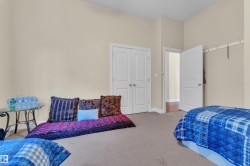 Carpeted bedroom featuring baseboards and a closet - 