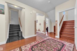 Entryway with stairway, hardwood / wood-style floors, and a textured ceiling - 