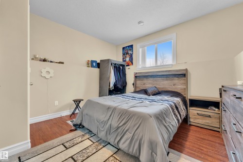Bedroom with wood finished floors and a textured ceiling - 2012 69 Street, Edmonton, AB - Indoor Photo Showing Bedroom