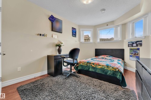 Bedroom with light wood-type flooring and a textured ceiling - 2012 69 Street, Edmonton, AB - Indoor Photo Showing Bedroom
