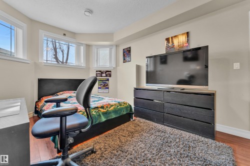 Bedroom with wood finished floors and a textured ceiling - 2012 69 Street, Edmonton, AB - Indoor