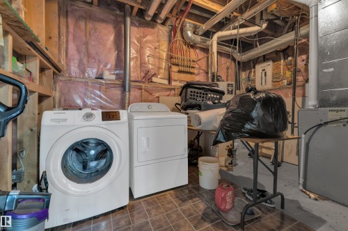 Laundry area with independent washer and dryer, heating unit, and electric panel - 2012 69 Street, Edmonton, AB - Indoor Photo Showing Laundry Room