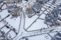 Snowy aerial view featuring a residential view - 
