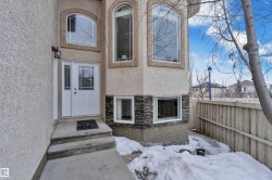 Doorway to property featuring stucco siding and stone siding - 
