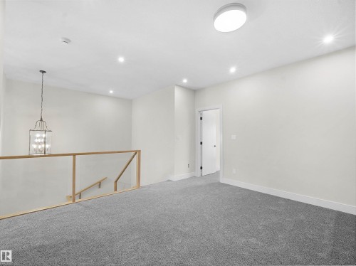 Carpeted spare room with a chandelier and recessed lighting - 46 Waverly Way, Fort Saskatchewan, AB - Indoor Photo Showing Other Room