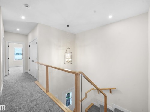 Hallway featuring carpet, a chandelier, an upstairs landing, and recessed lighting - 46 Waverly Way, Fort Saskatchewan, AB - Indoor Photo Showing Other Room