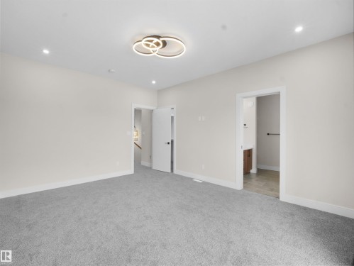 Unfurnished bedroom with light carpet, recessed lighting, and connected bathroom - 46 Waverly Way, Fort Saskatchewan, AB - Indoor Photo Showing Other Room