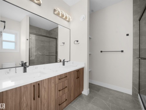 Full bathroom featuring double vanity and a stall shower - 46 Waverly Way, Fort Saskatchewan, AB - Indoor Photo Showing Other Room