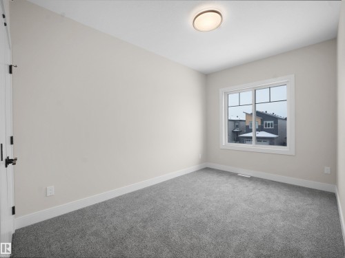 Carpeted empty room featuring baseboards - 46 Waverly Way, Fort Saskatchewan, AB - Indoor Photo Showing Other Room