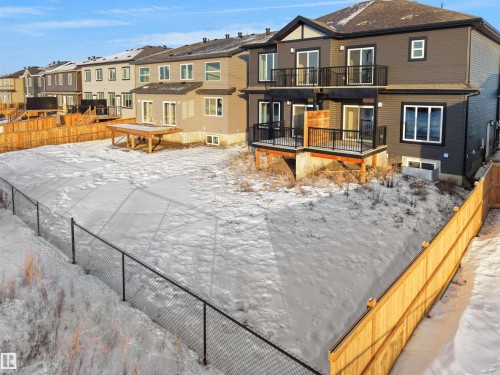 Snow covered back of property featuring a balcony and a residential view - 46 Waverly Way, Fort Saskatchewan, AB - Outdoor