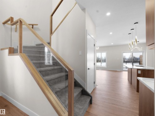 Staircase featuring wood finished floors and recessed lighting - 46 Waverly Way, Fort Saskatchewan, AB - Indoor Photo Showing Other Room
