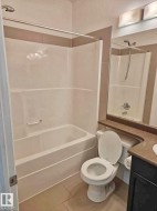 Full bathroom with vanity, tile patterned flooring, and shower / washtub combination - 
