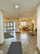 Community lobby featuring a textured ceiling and recessed lighting - 
