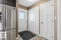 Doorway with wood finished floors and a textured ceiling - 